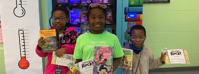 Beanstack Top Readers Pose after getting a book from the book vending machine. 