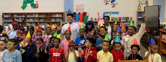 Students pose for a picture at the monthly birthday celebration.